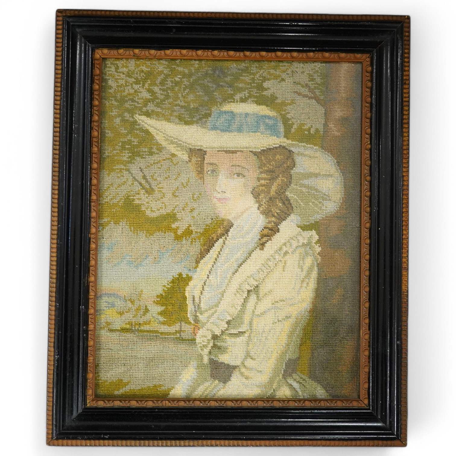 After Reynolds, a petite point embroidery portrait of a young lady wearing a large brimmed hat. 15.5cm wide, 20cm high. Condition - good